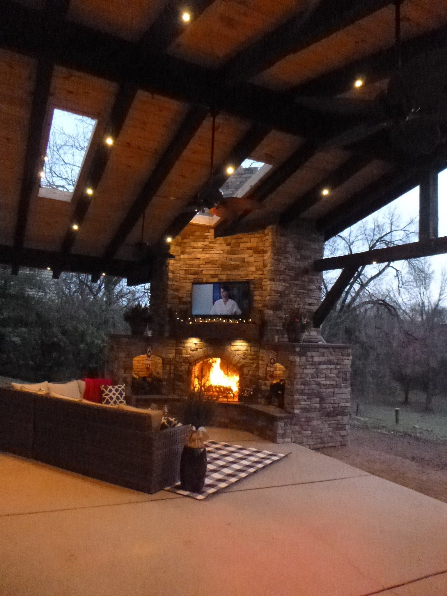 A living room with a fireplace and a television