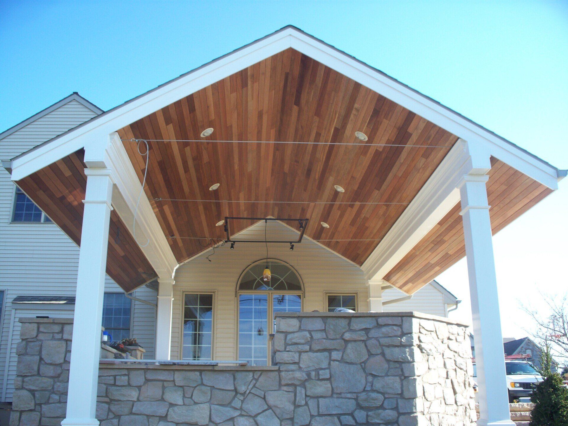 A house with a wooden roof and a stone wall
