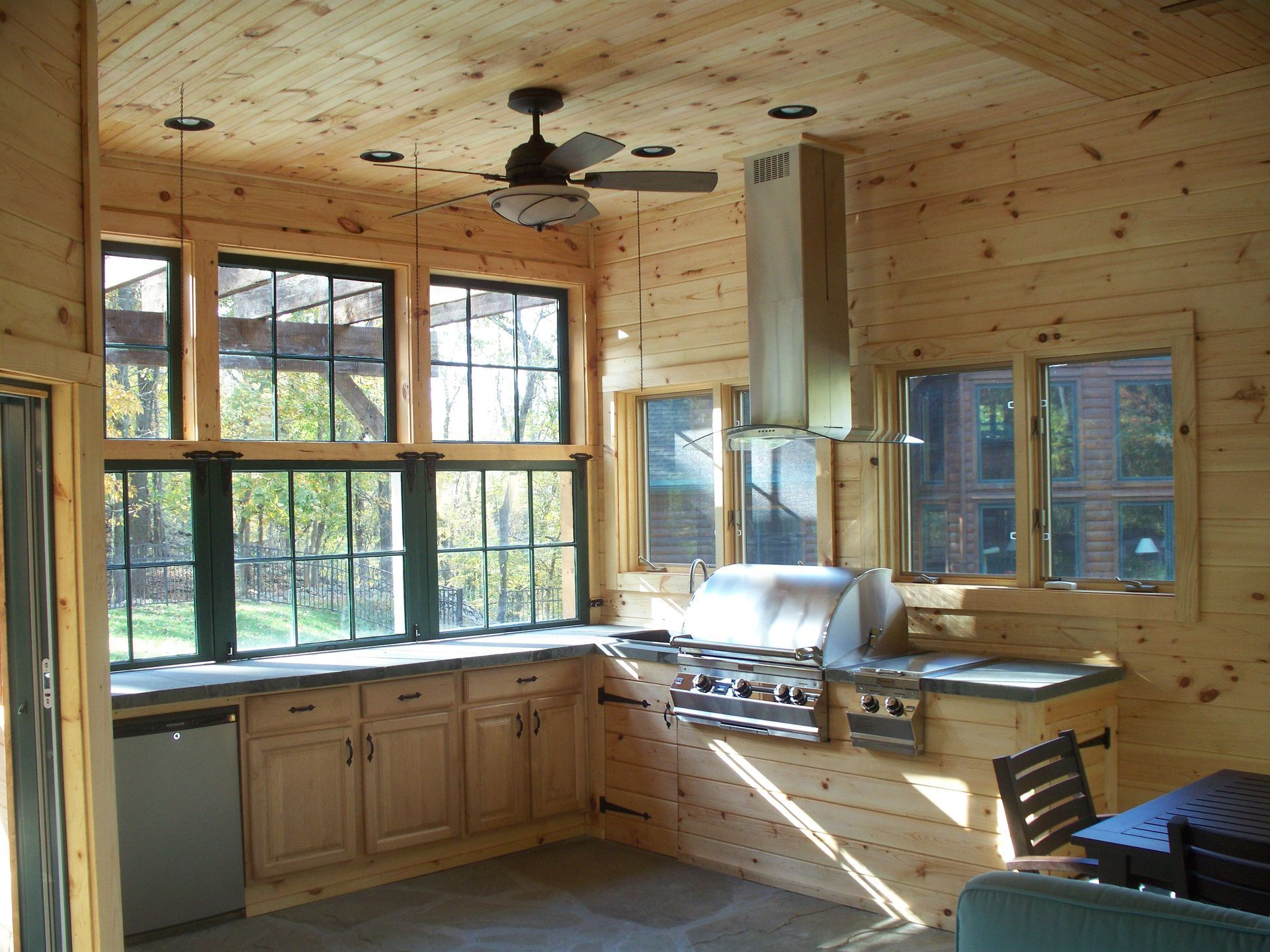 A kitchen with a grill and a ceiling fan