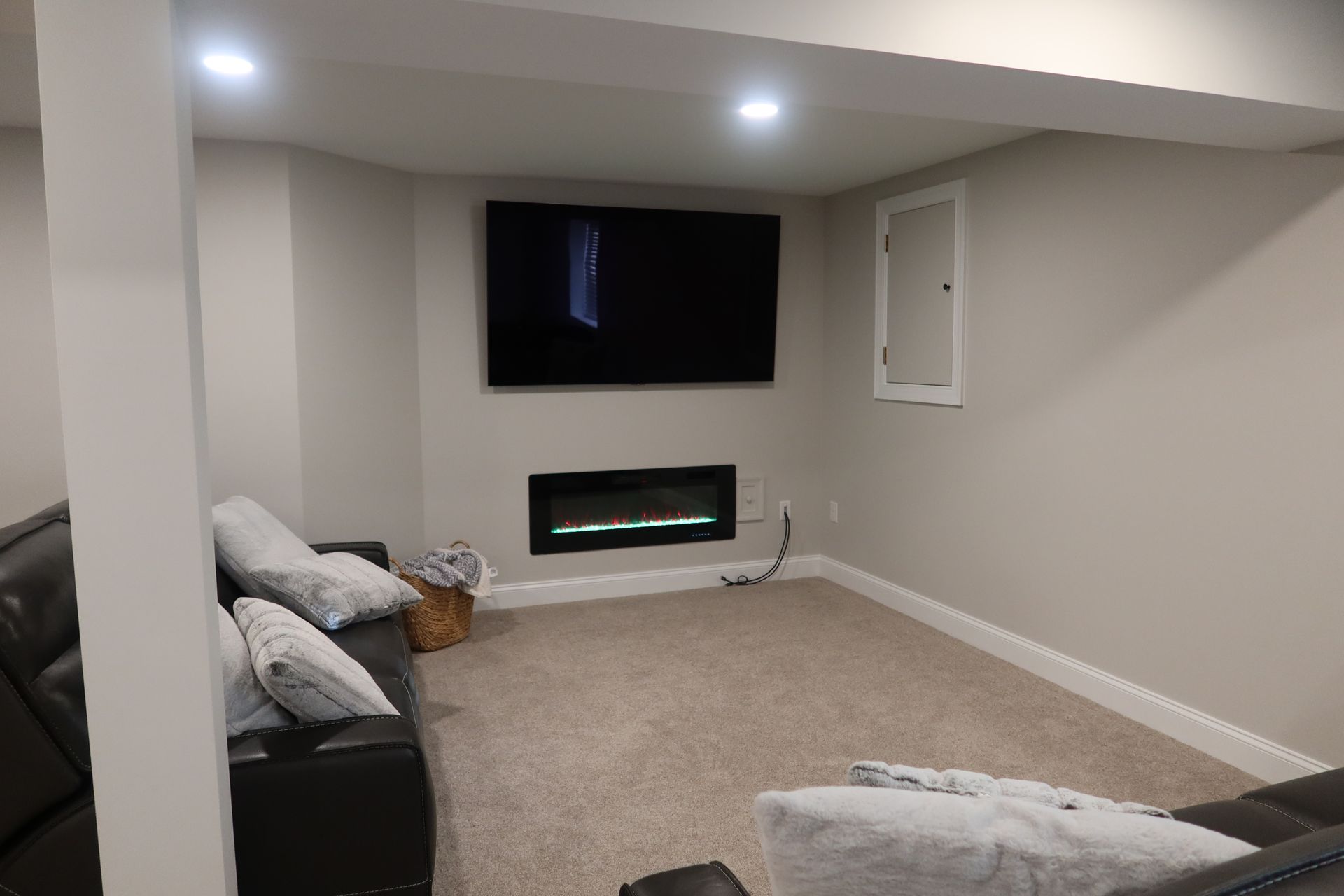 A living room with a fireplace and a flat screen tv.