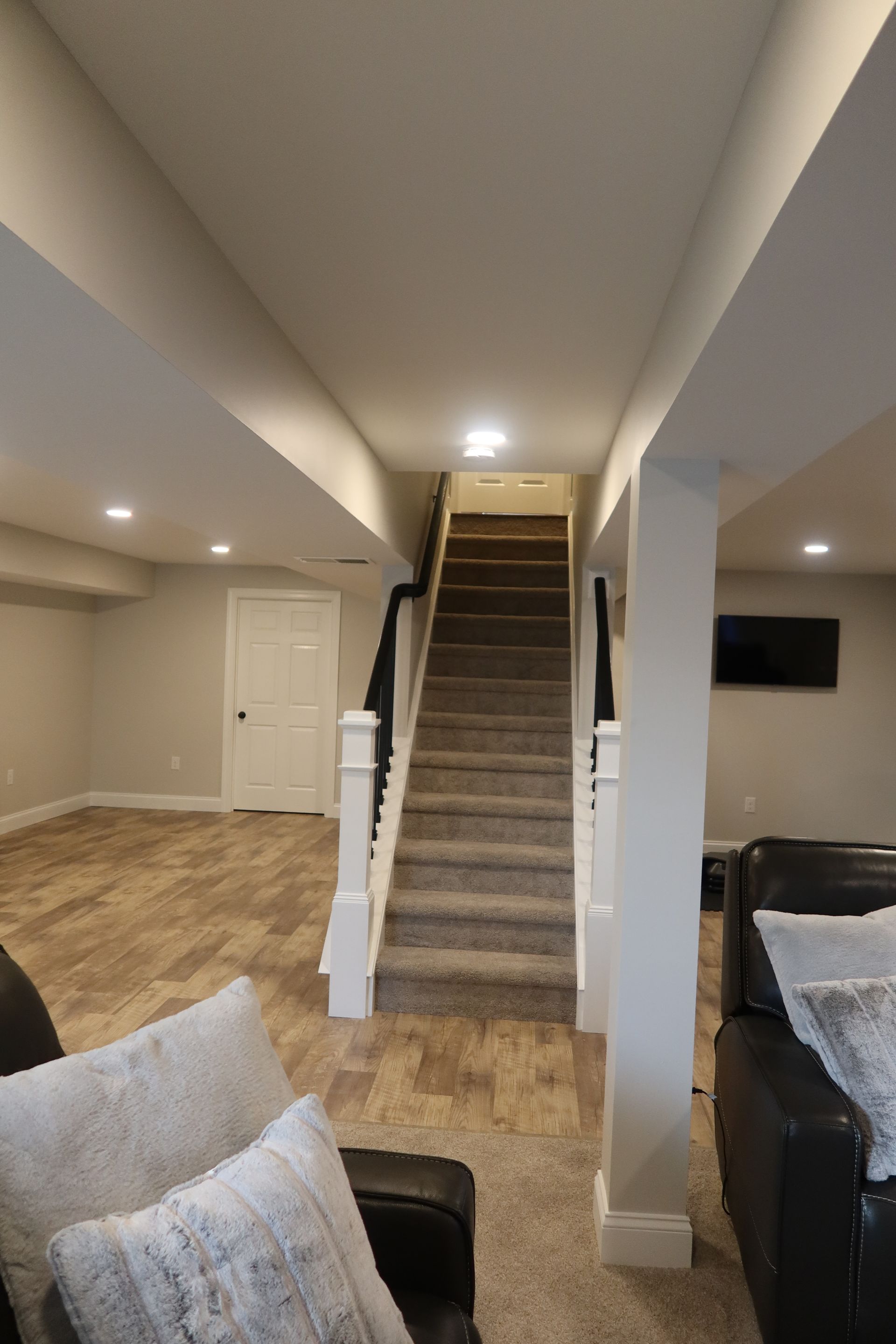 A living room with a staircase leading up to the second floor.