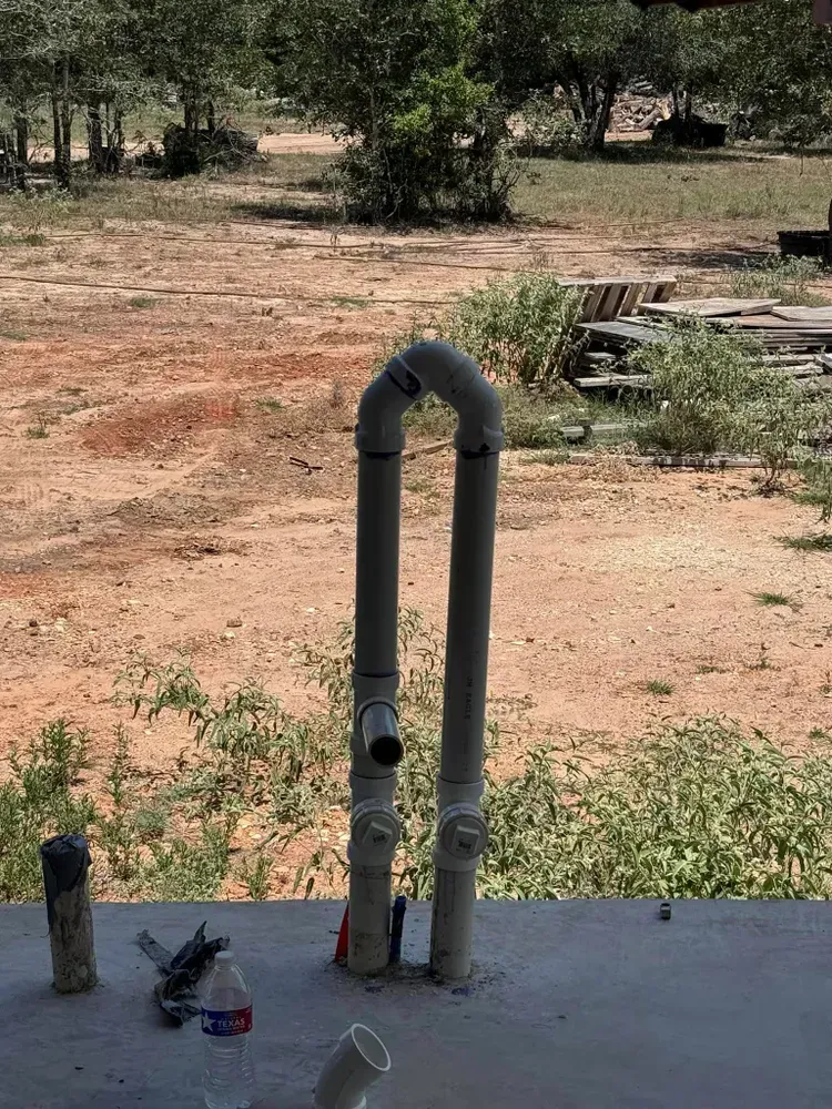 A couple of pipes sitting on top of a concrete surface.