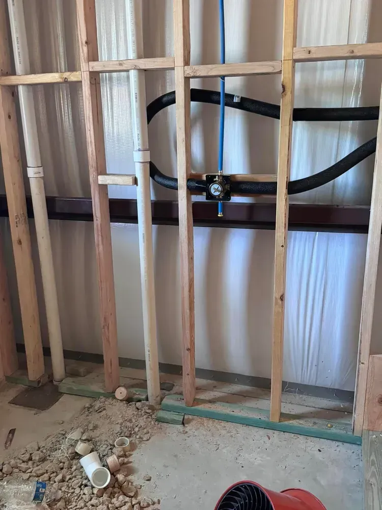 A wooden frame with pipes coming out of it