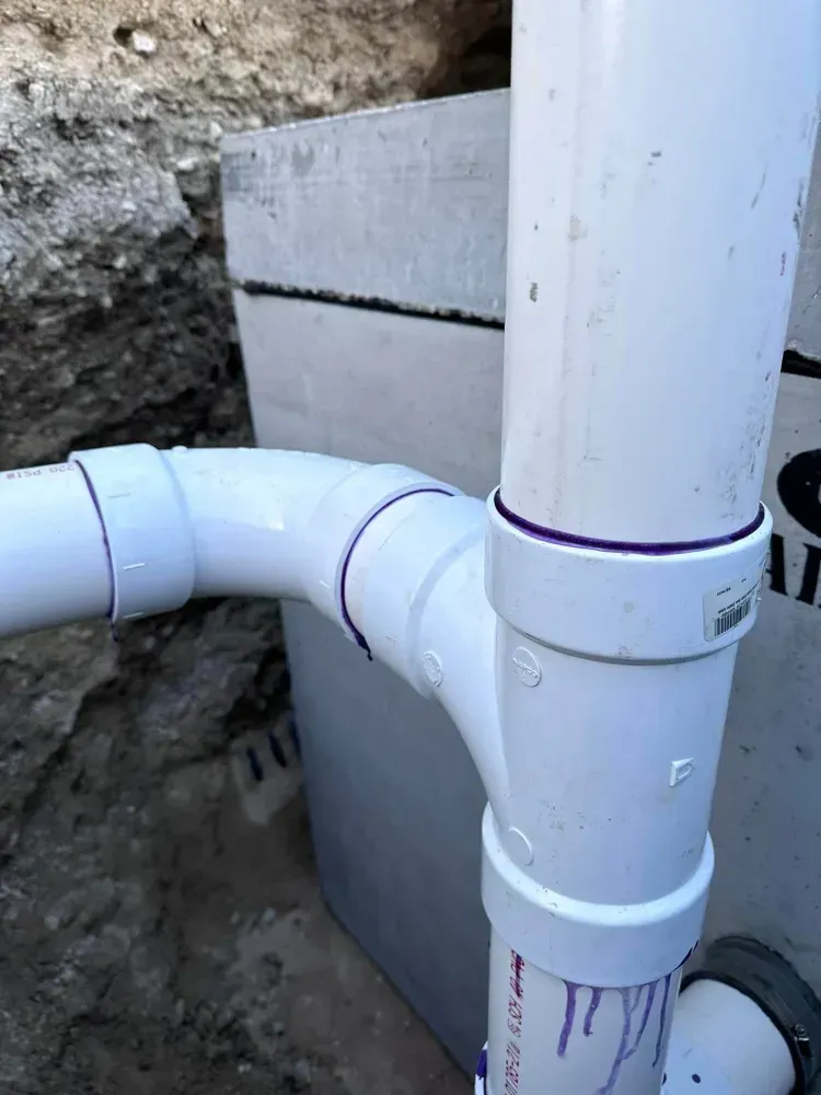 A close up of a white pipe with a purple stripe on it