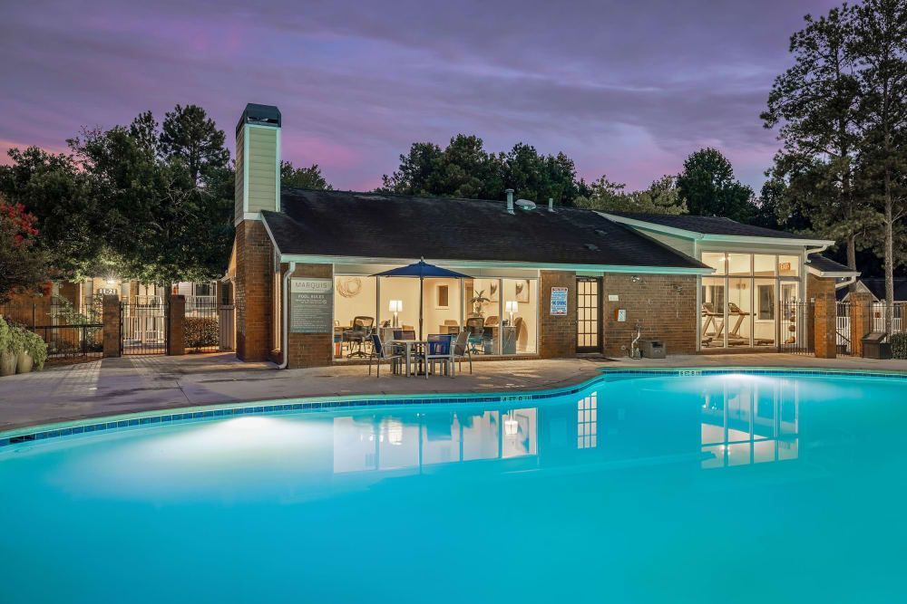A large resort-style swimming pool in front of the clubhouse at Marquis at Perimeter Center in Atlanta, GA.