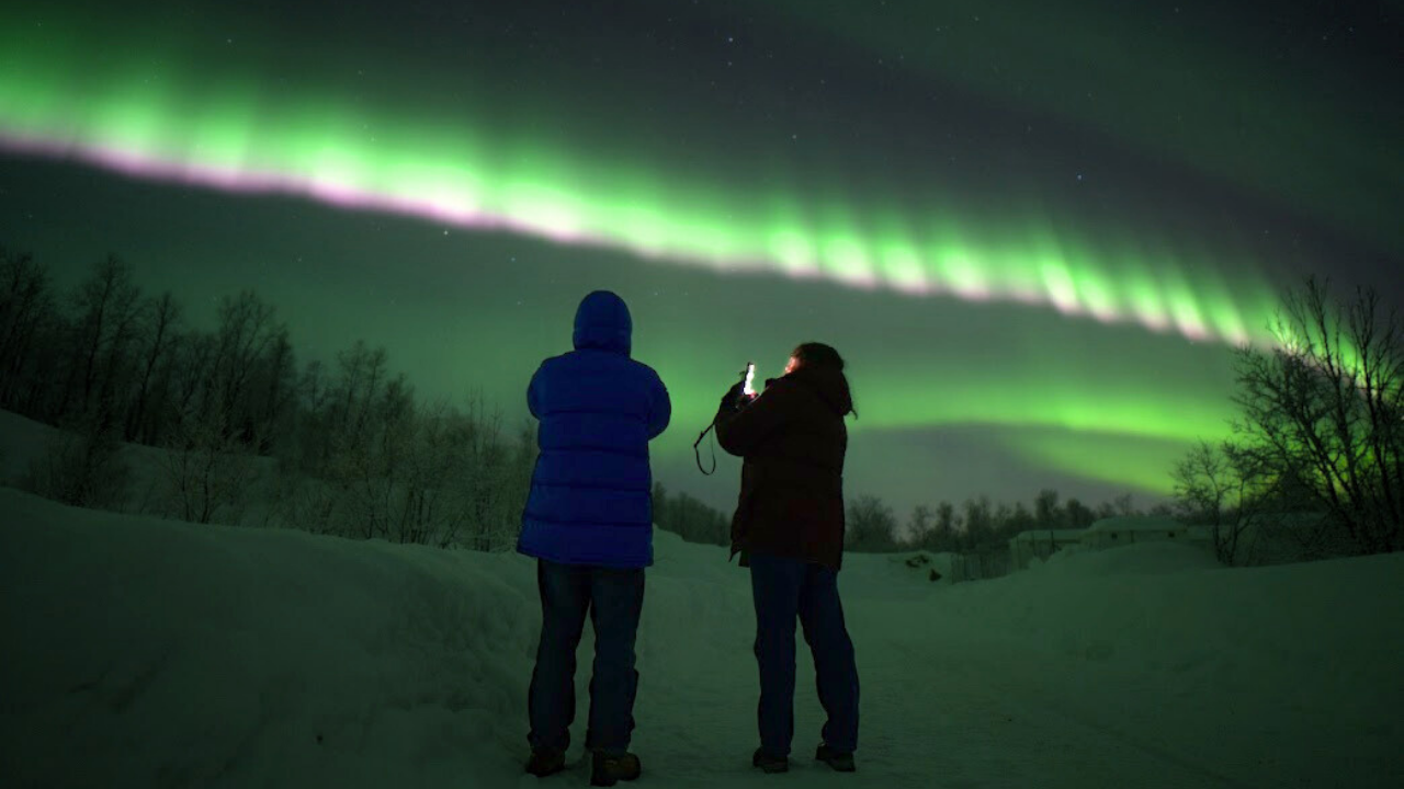 couples under aurora northern light in tromso norway