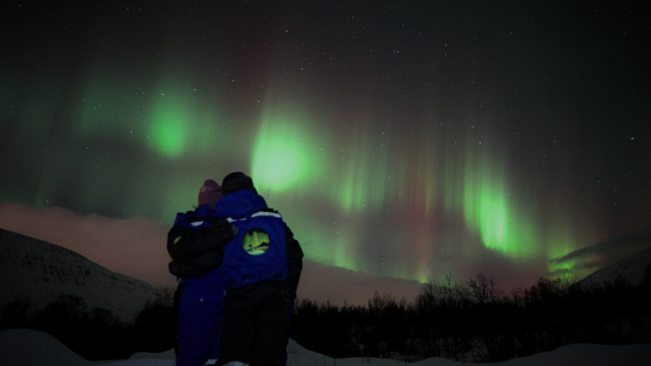 couples under aurora northern light in tromso norway