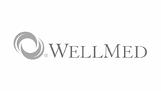 A wellmed logo with a swirl in the middle on a white background.