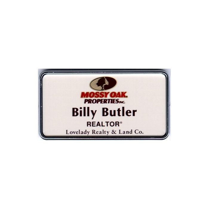 White thermal printed plastic name badge with protective dome, set in silver executive frame.