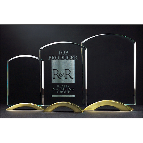 Glass award with curved top on gold metal base.