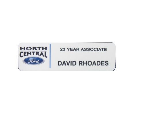 White thermal printed plastic name badge with company logo and name.