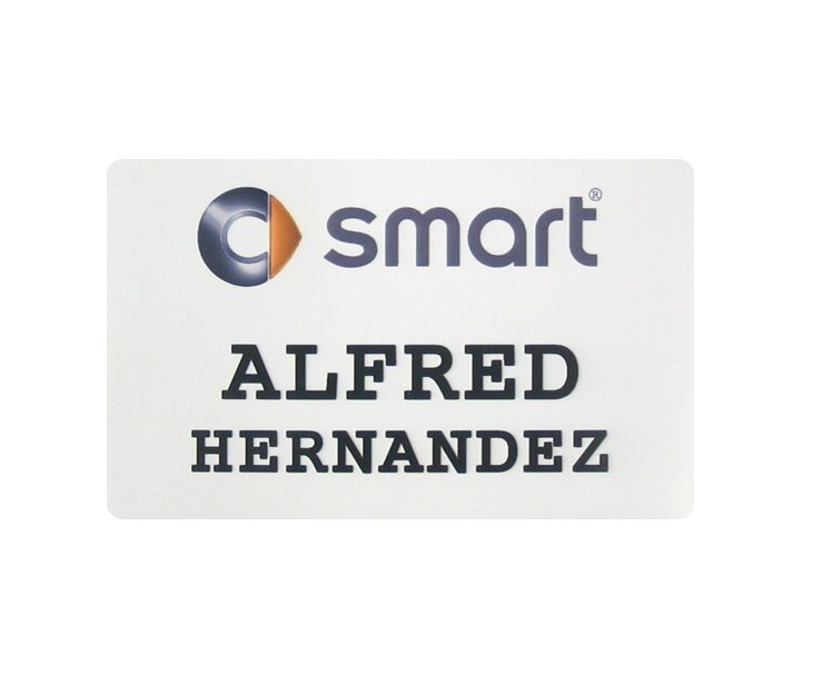 White thermal printed plastic name badge with company logo and name.