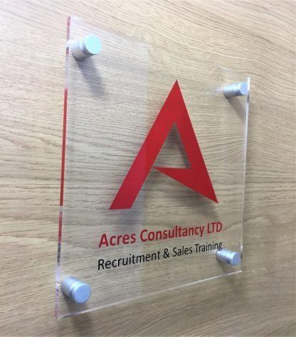 Lettering and branding on acrylic corporate office sign.