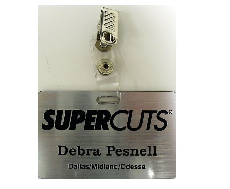 Laser engraved name badge with logo, name, title, and punch out for clip.