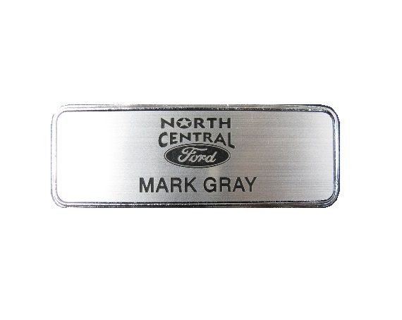 Laser engraved brushed aluminum plastic name badge in silver deluxe frame.
