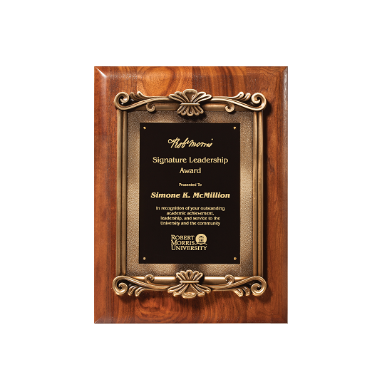 Ornate metal frame on walnut plaque.