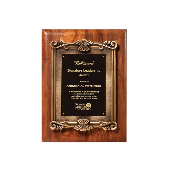 Ornate metal frame on walnut plaque.