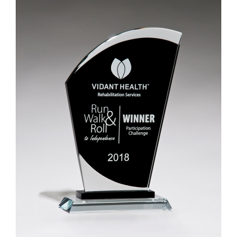 Sail shaped glass recognition award with black background.