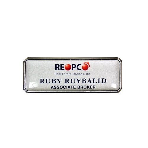 Silver thermal printed plastic name badge with protective dome, set in silver deluxe frame.