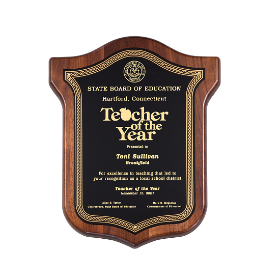Shield wooden recognition plaque with ornate gold accents.