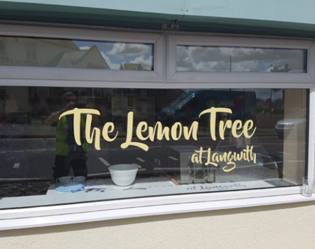 Business logo cut out vinyl on exterior glass window.