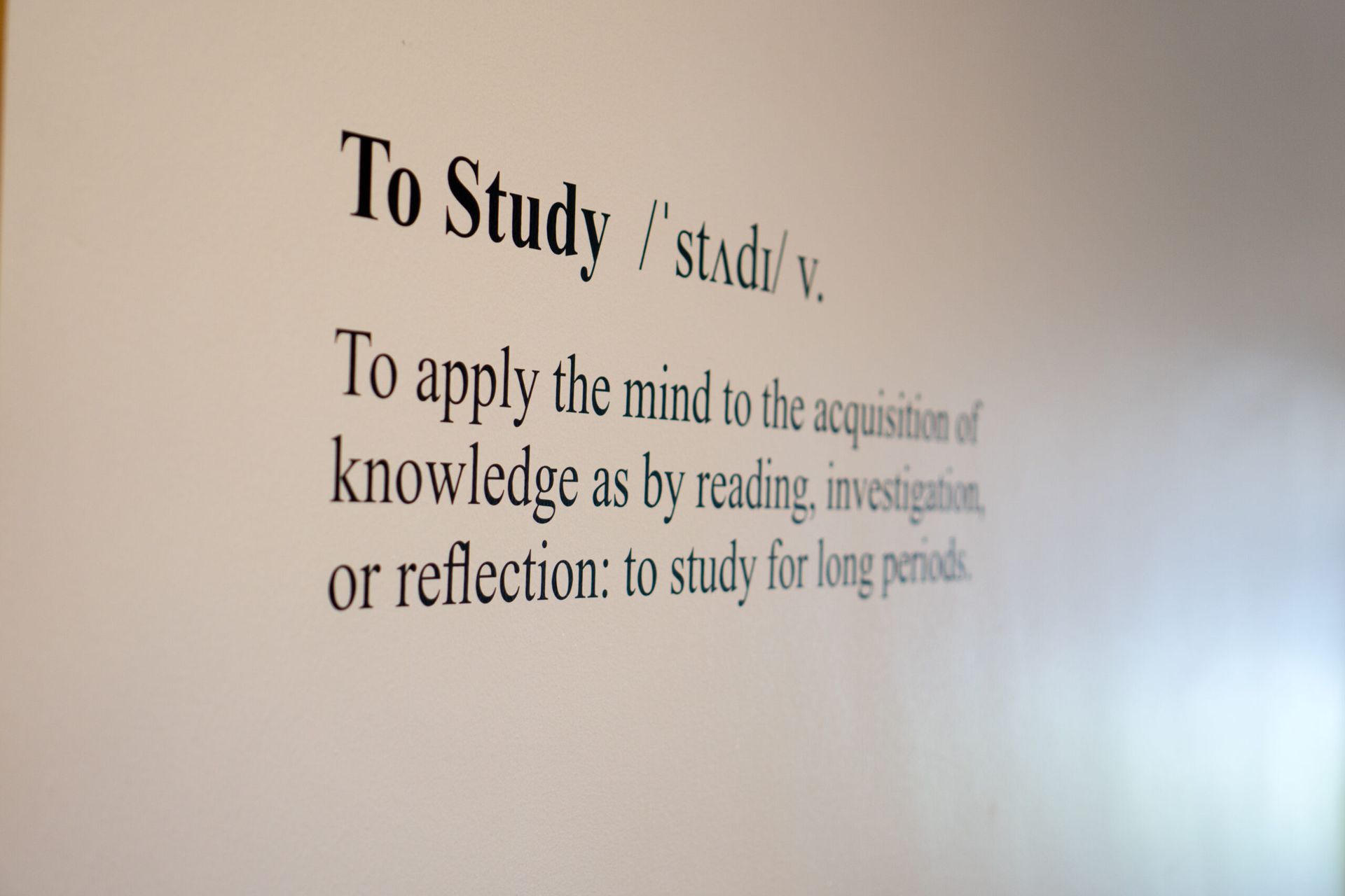 Vinyl lettering cut out on interior wall.