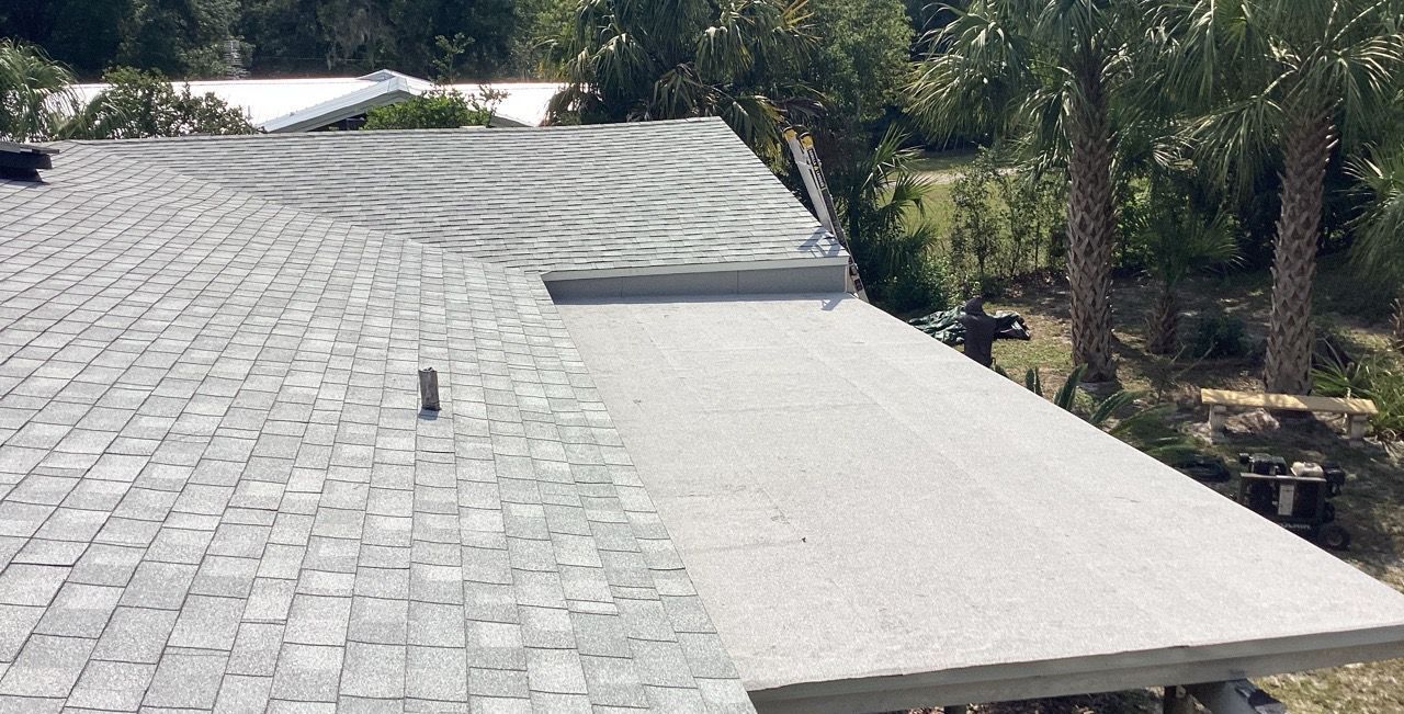 The roof of a house with a wooden roof and a black gutter.