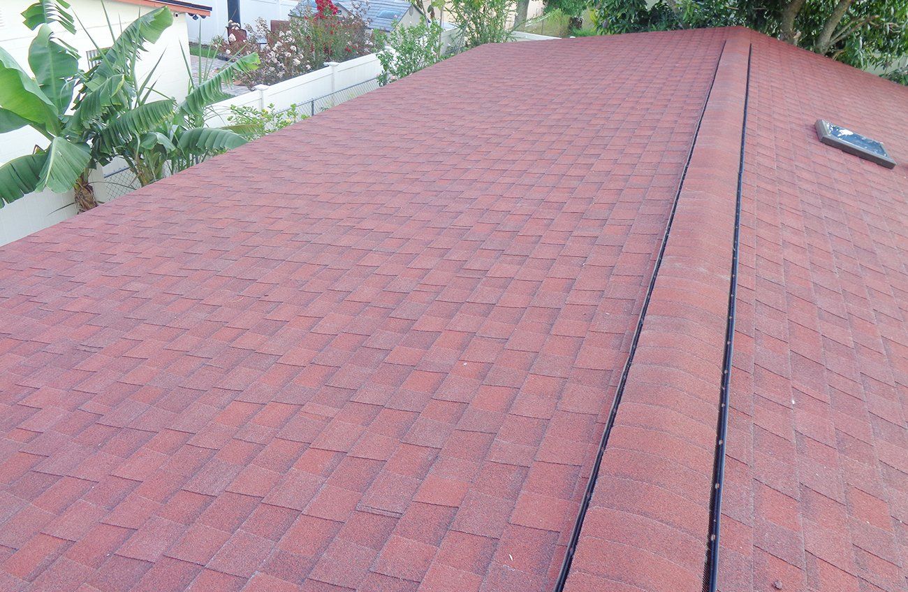 A red roof with a black stripe on the side of it