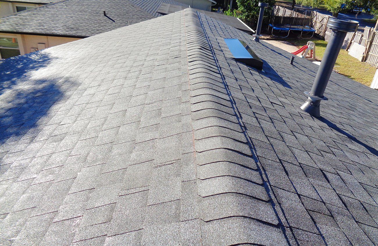 A close up of a roof with a chimney on it.