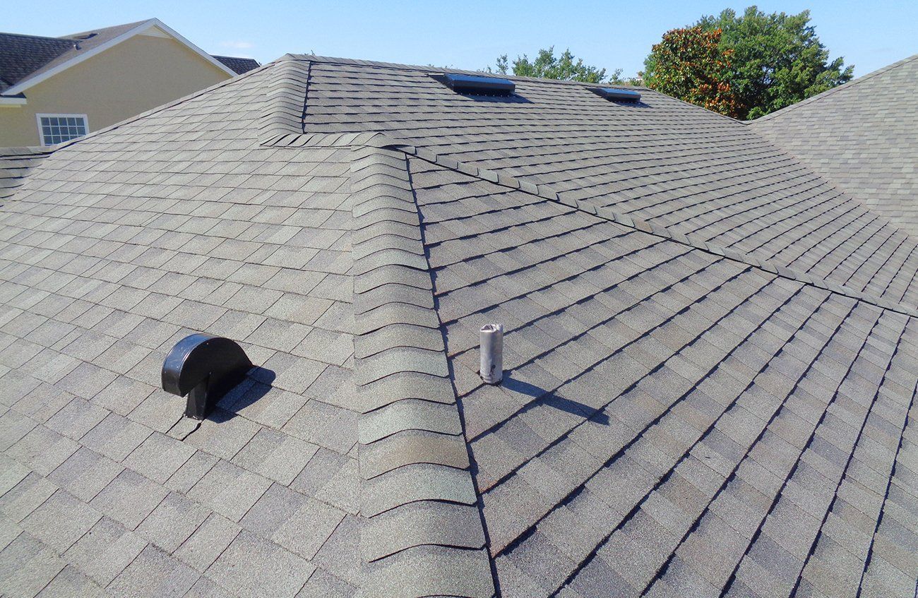 A close up of a roof with a vent on it.