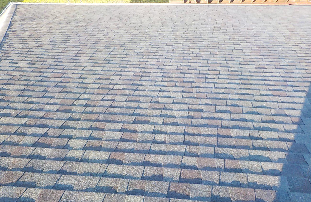 A close up of a roof with a lot of shingles on it.