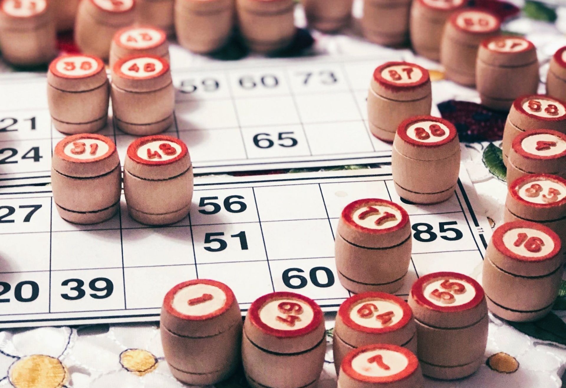 Wooden barrels with numbers on top sit on a bingo card.