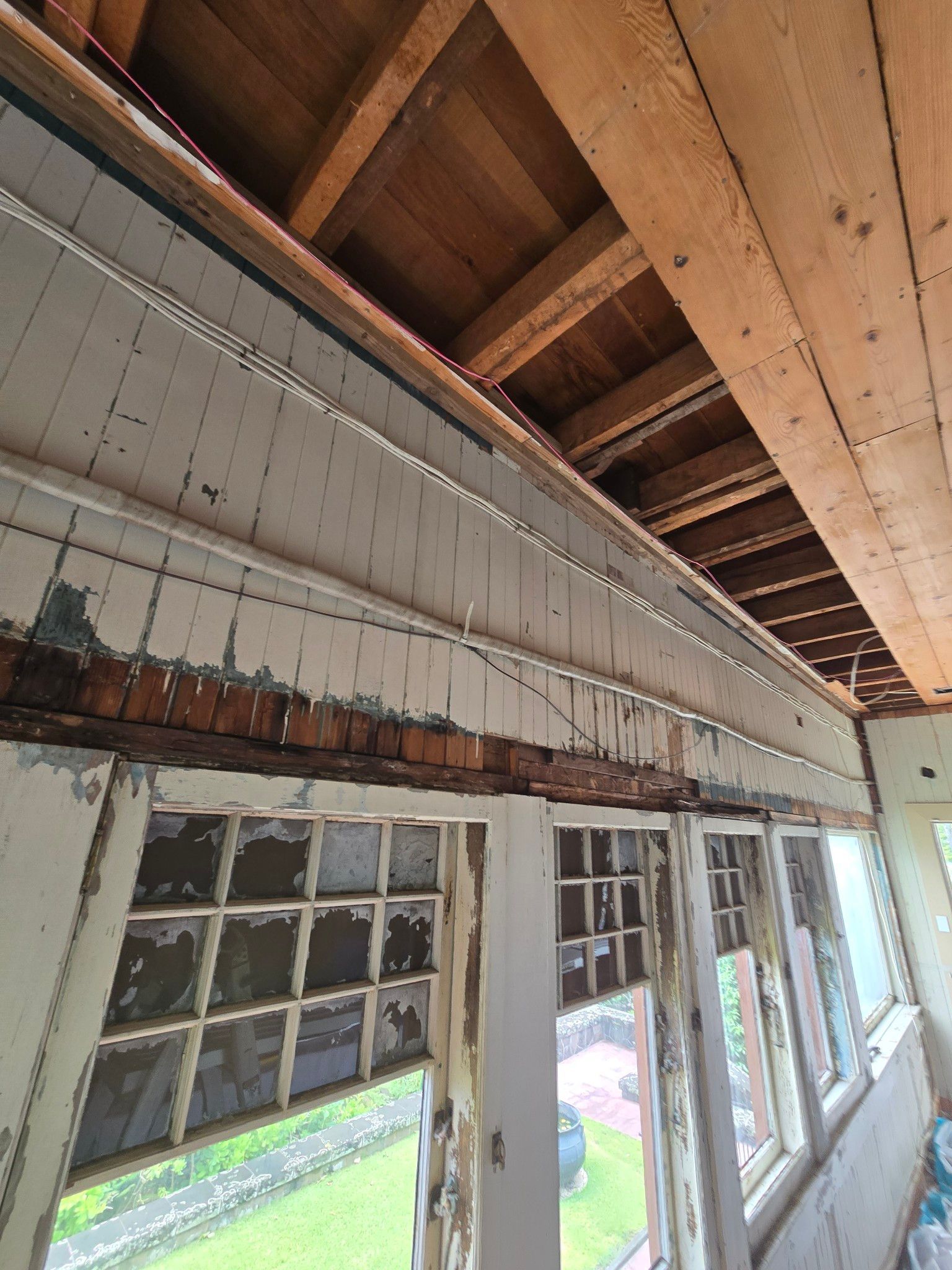 Rooftop with construction materials under a bright blue sky with clouds.
