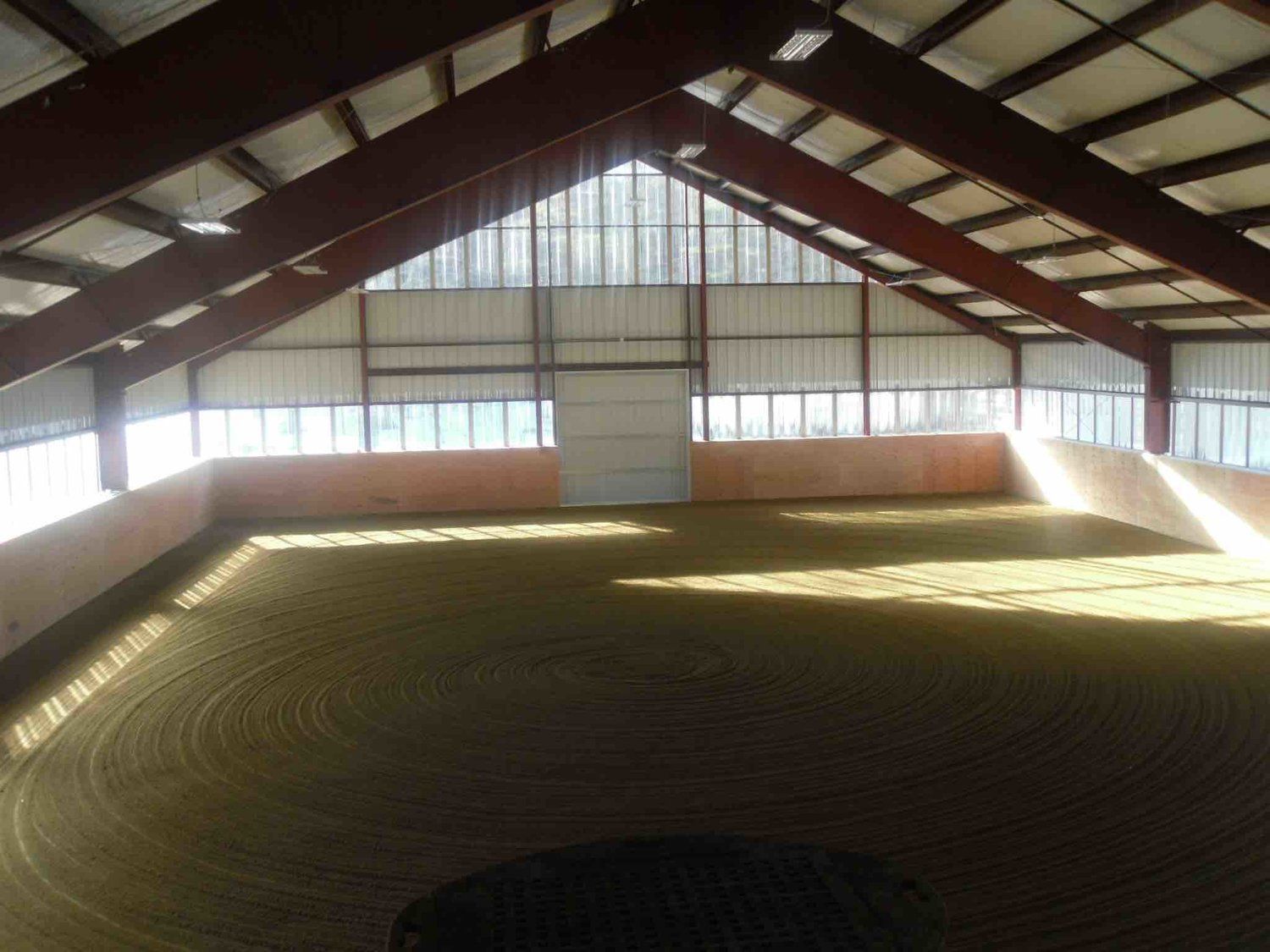 A large indoor arena with a lot of windows