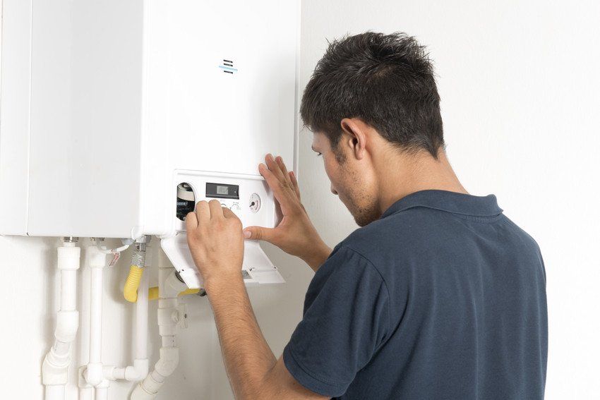 Engineer fixing a boiler