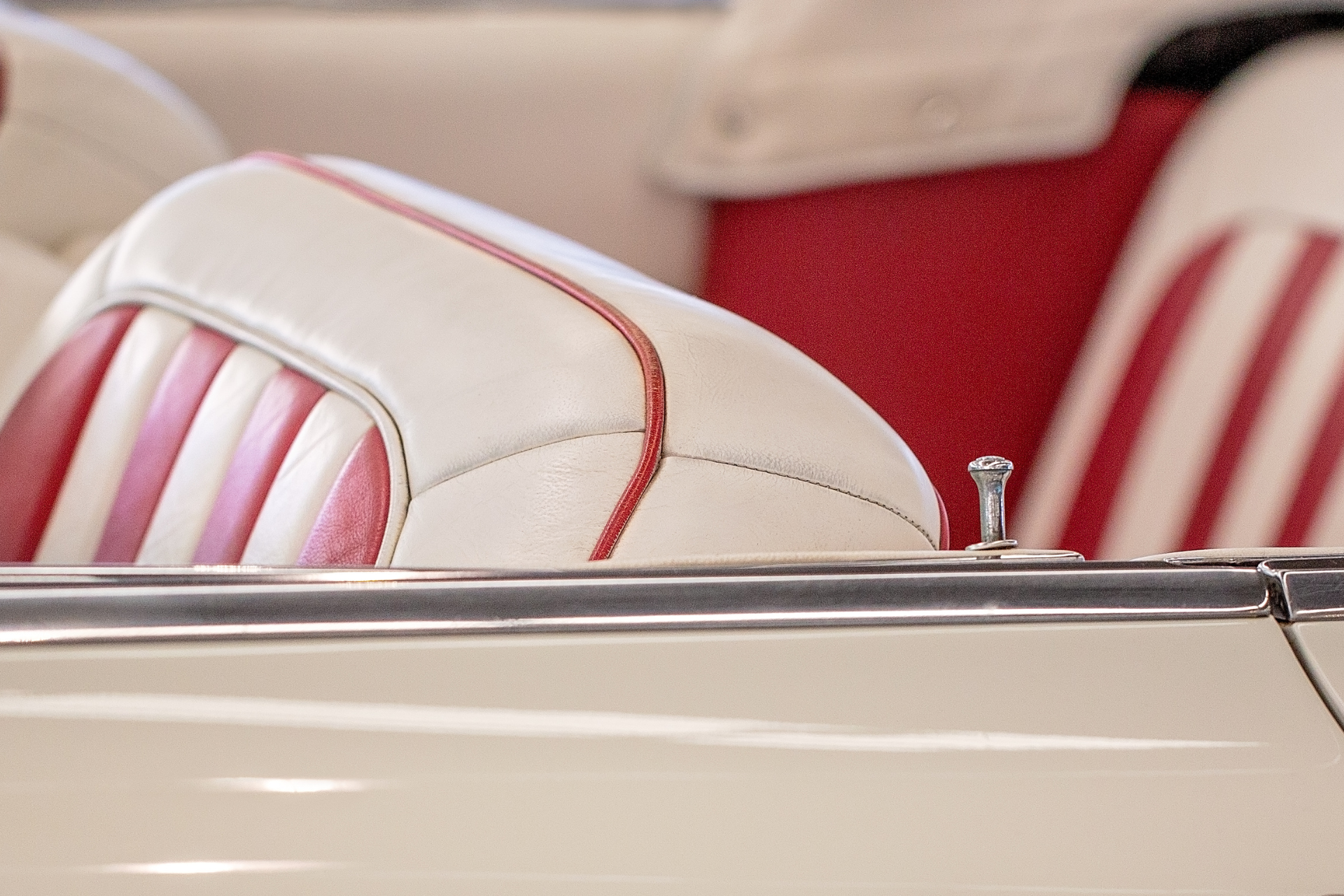 A close up of a red and white striped seat on a boat
