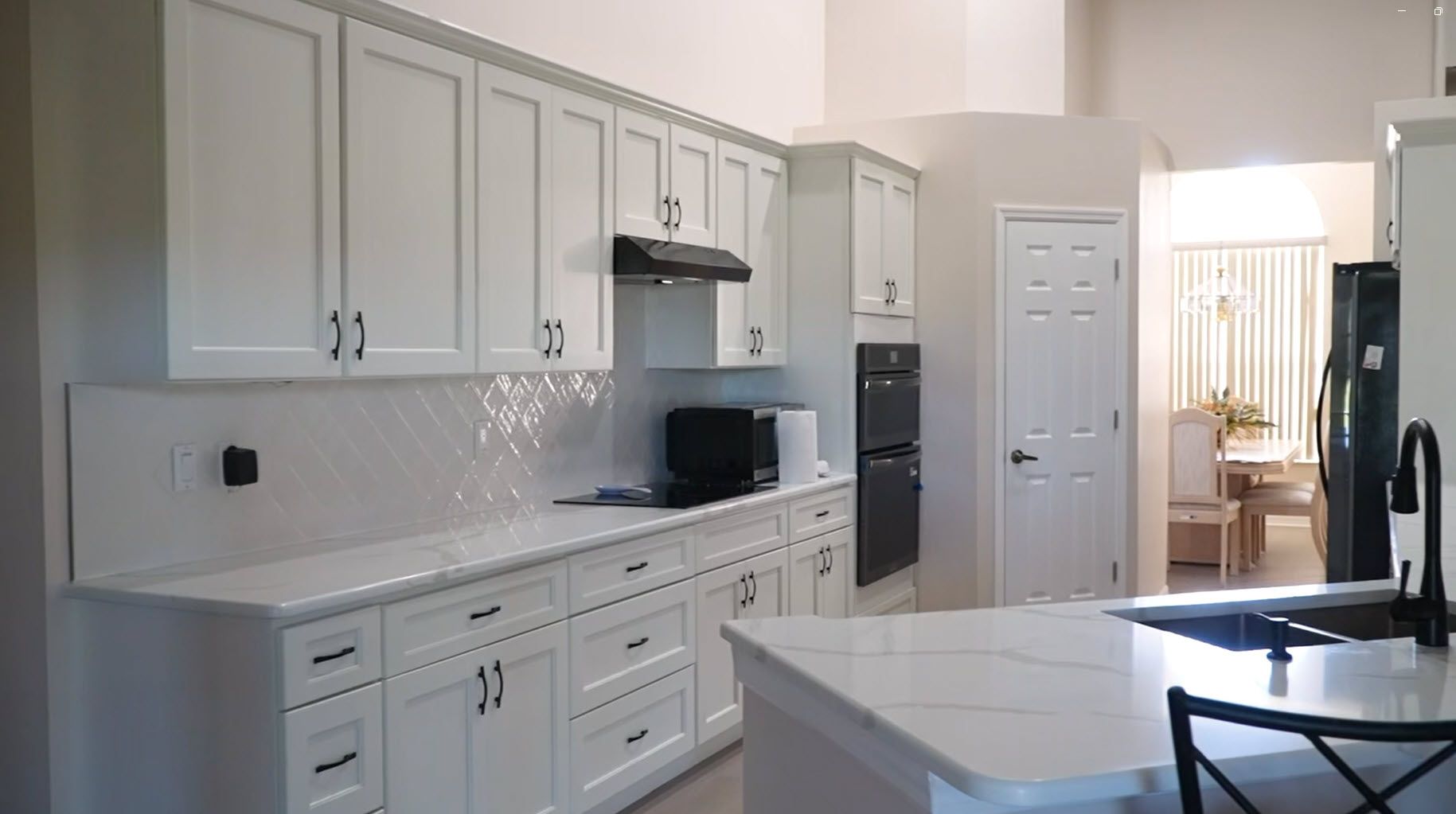Finished kitchen with white cabinets and quartz countertops