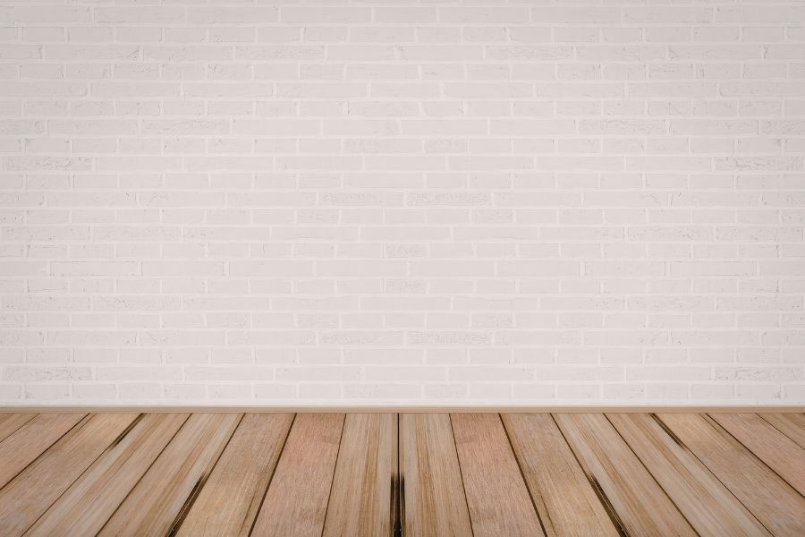 Cross-section view of removed flooring showing swollen OSB subfloor with visible mold growth on the underside, in a Central Florida home