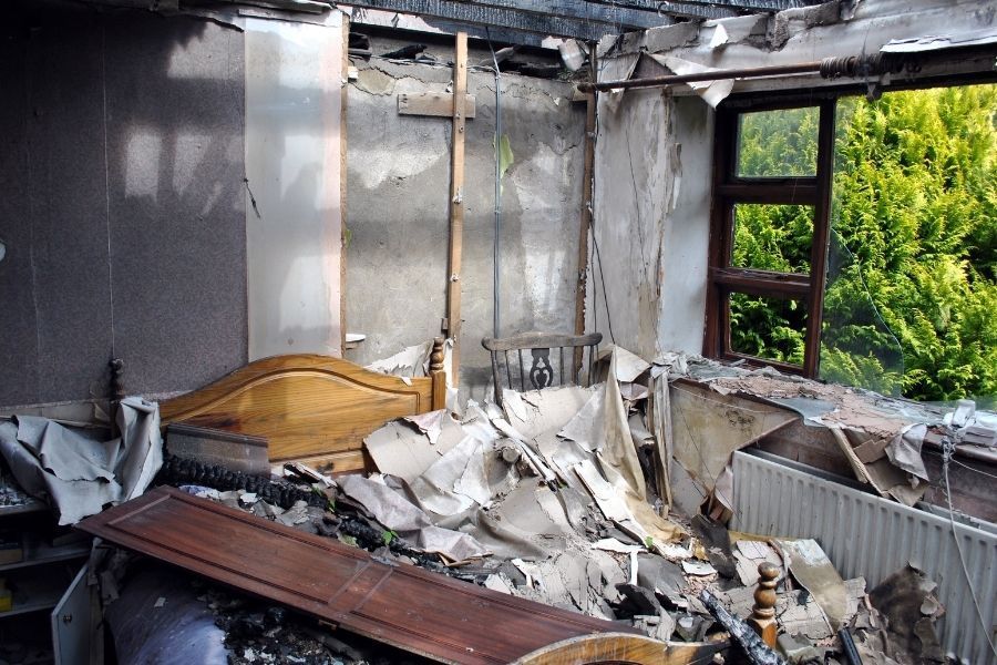 Bedroom with collapsed ceiling from severe fire damage