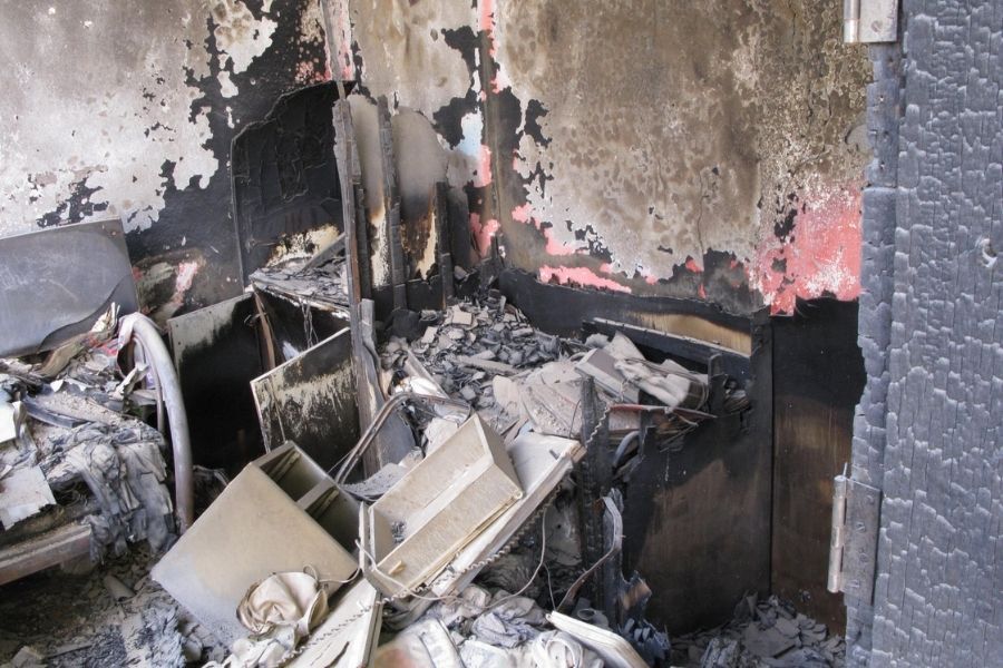 Interior room showing extensive fire and soot damage