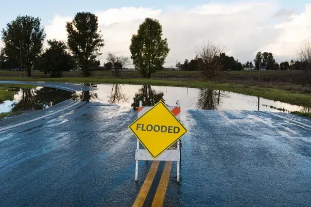 FFF's Team is serving a Flooded warning sign on a wet road in Lake County, FL