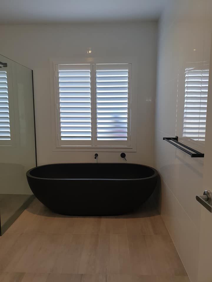White plantation shutters in bathroom