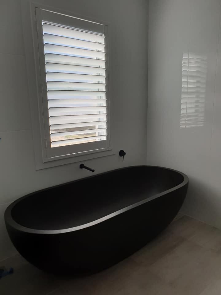 White plantation shutters in bathroom