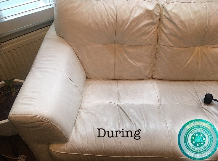 A white leather couch with the word during written on it