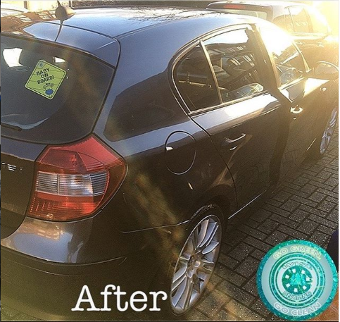 A black car is parked on a brick driveway with the words after on the bottom