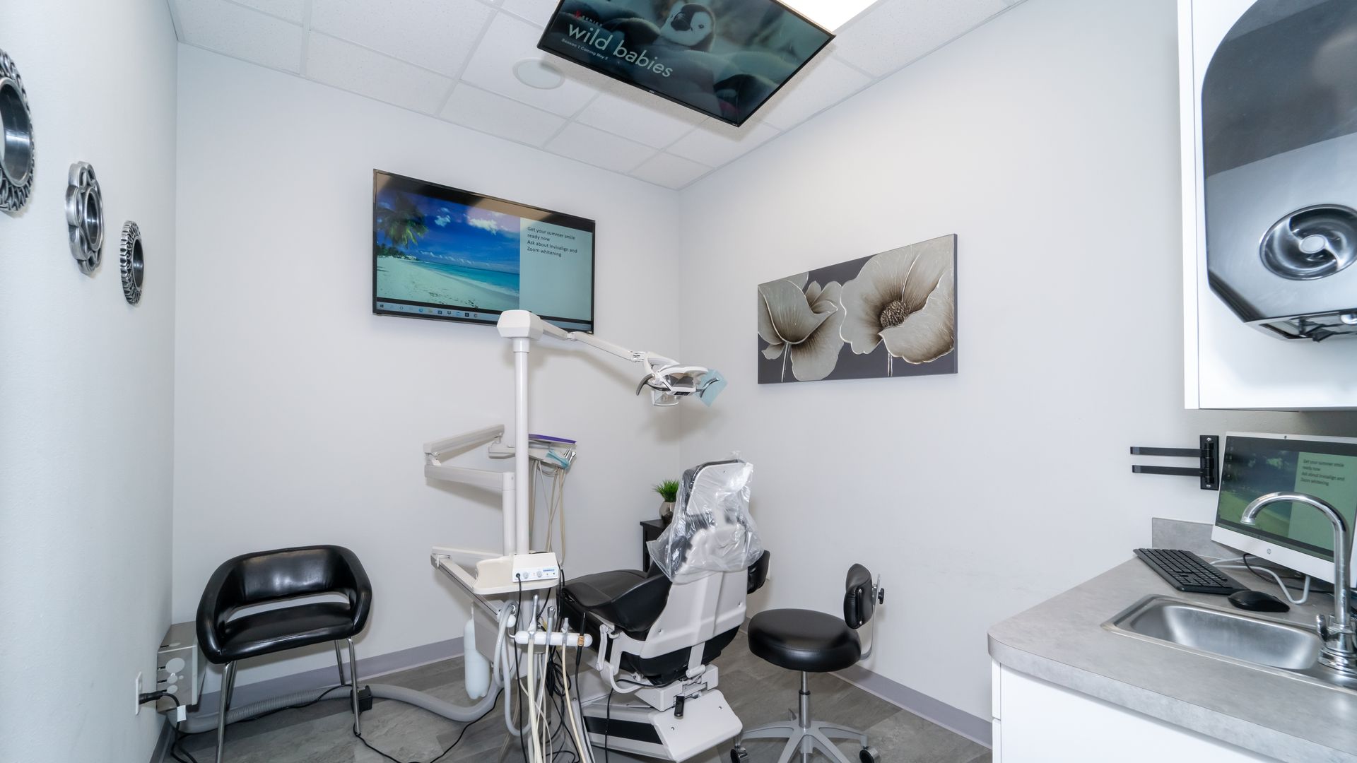A dental office with a dental chair and a sink.