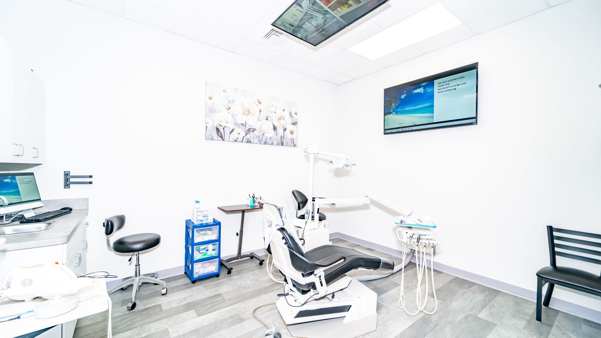 A dental office with a dental chair and a bench.