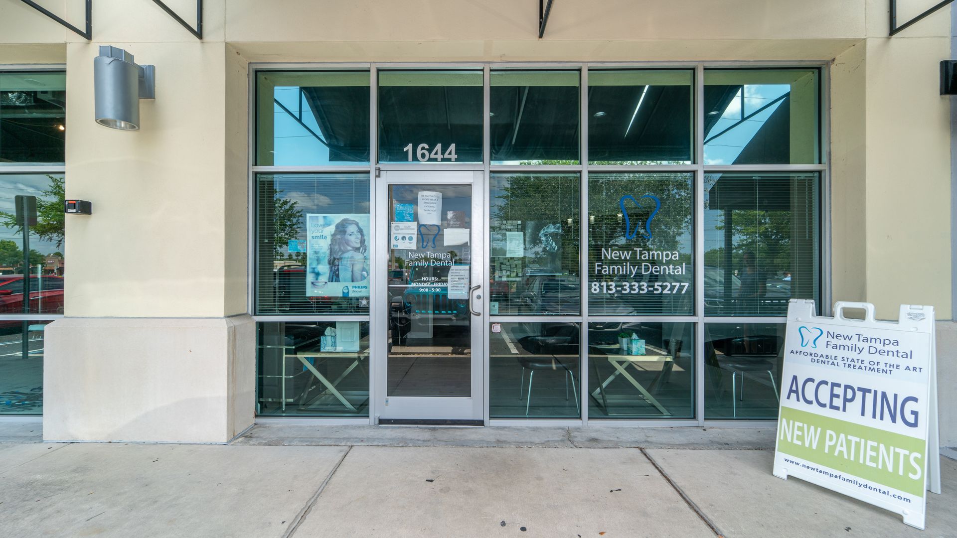 The front of a building with a sign that says accepting new patients.