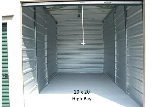 Empty 10x20 High Bay storage unit. Metal walls and floor, open door.