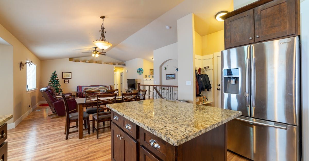 A kitchen with stainless steel appliances and granite counter tops.